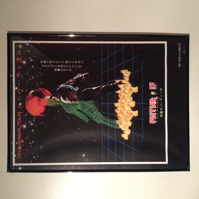 Framed Universal Tour artwork photographed on a wall.